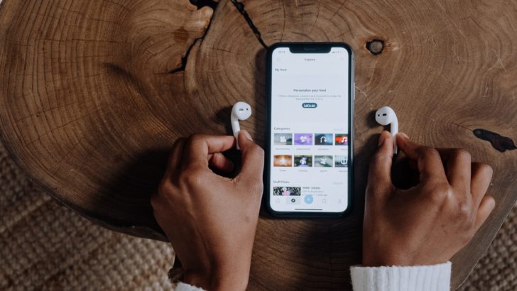 Photo of person holding airpods with iphone