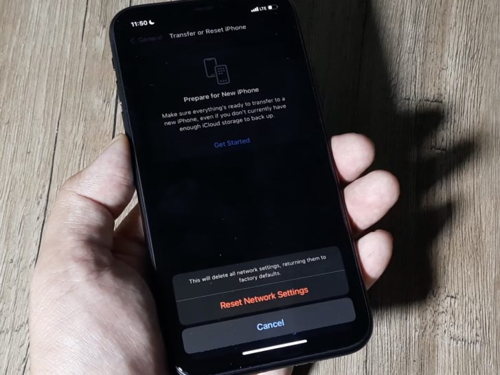 Photo of person resetting network settings on iphone