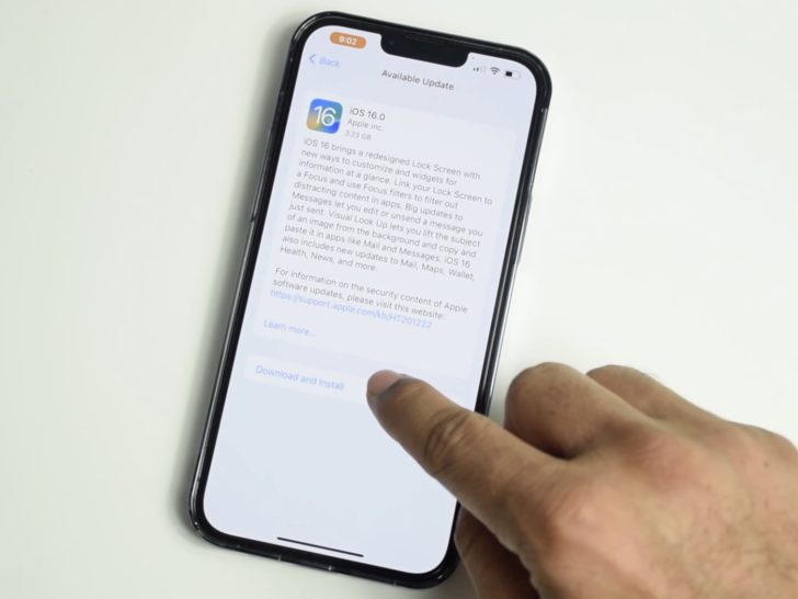 Photo of person updating iphone to ios 16
