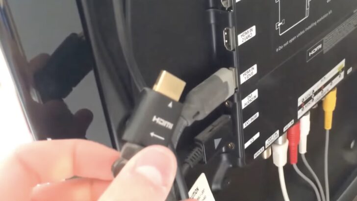 Photo of person reseating hdmi on tv port