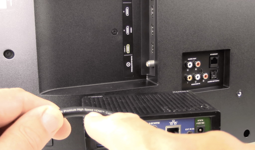 Photo of a person showing a high speed HDMI cable before plugging it into a TV