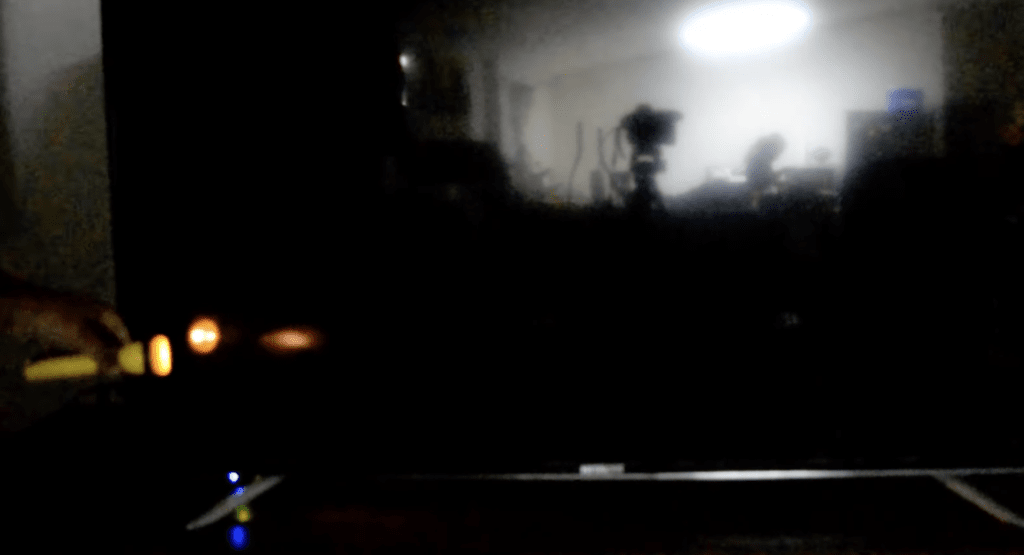 Photo of someone doing a flashlight test to check if a Samsung TV has a broken backlight