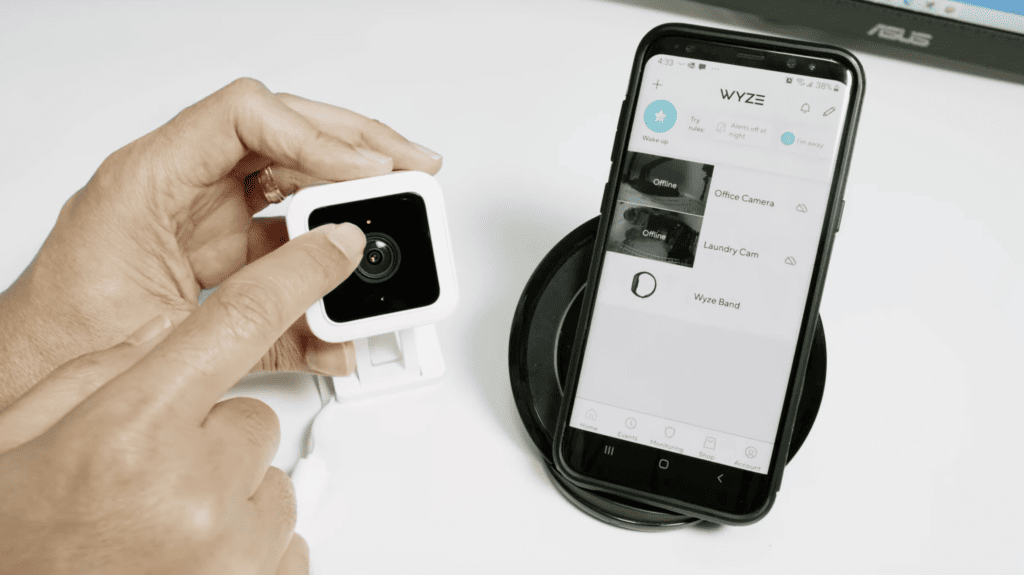 Photo of person resetting a Wyze camera pointing to the blinking red light