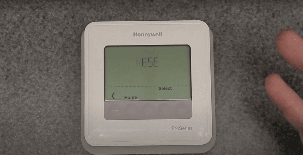 Honeywell thermostat showing reset on the screen