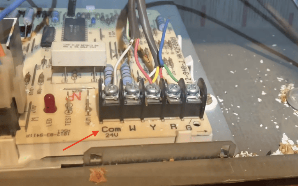 Photo of the C or Com terminal on the furnace motherboard