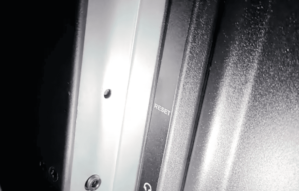 Photo of the tiny reset button at the back of a Roku TV