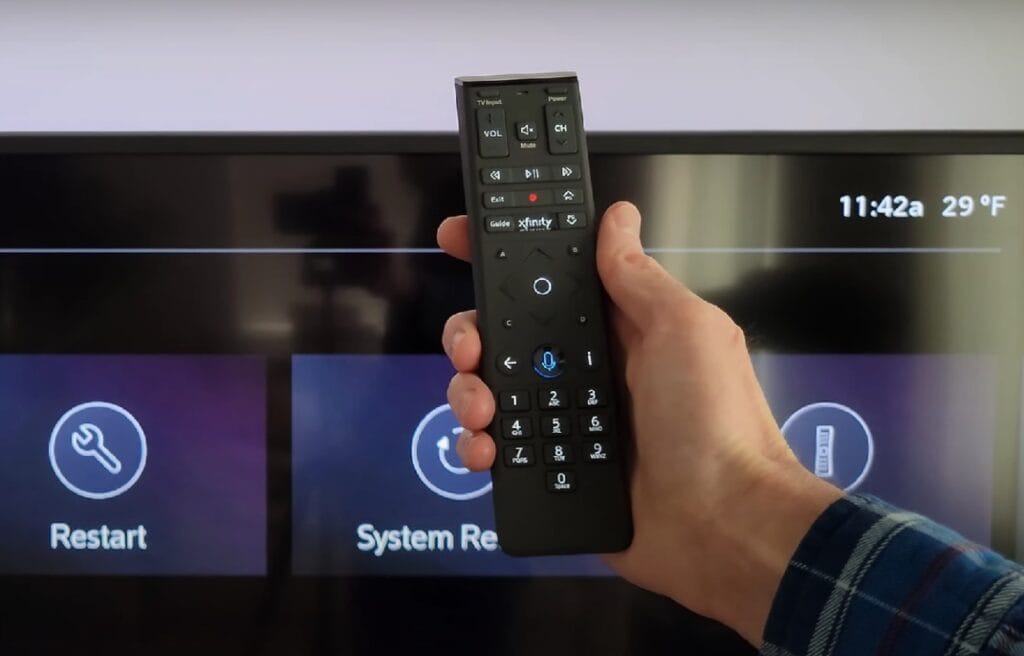 man holding an Xfinity remote control