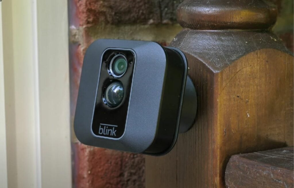 A Blink XT2 camera mounted on a wooden post