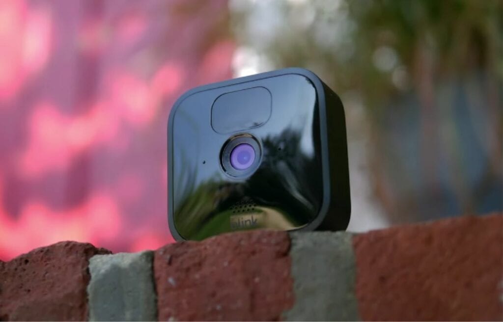 Blink outdoor camera on top of a red brick
