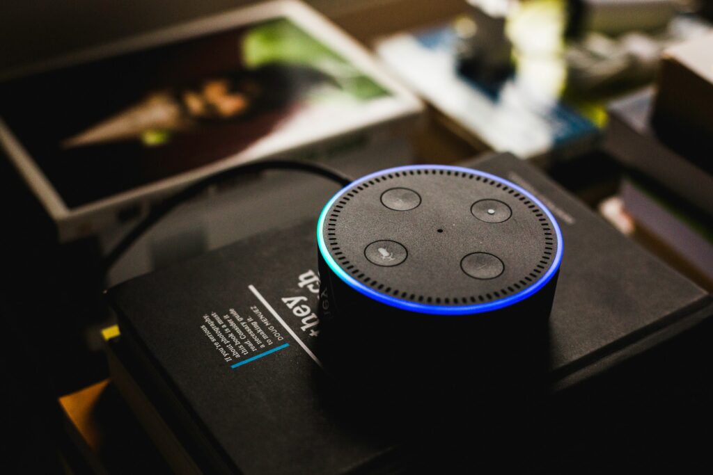 Alexa Echo Dot on top of books