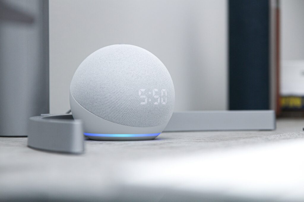 A gray Alexa echo dot showing the time
