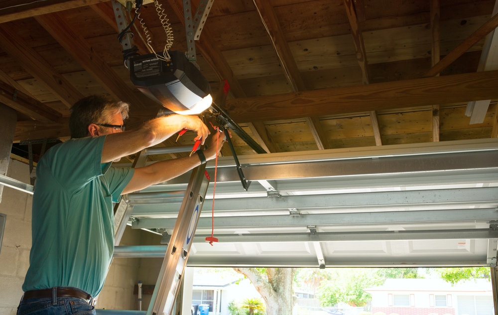 Professional fixing the garage door sensor
