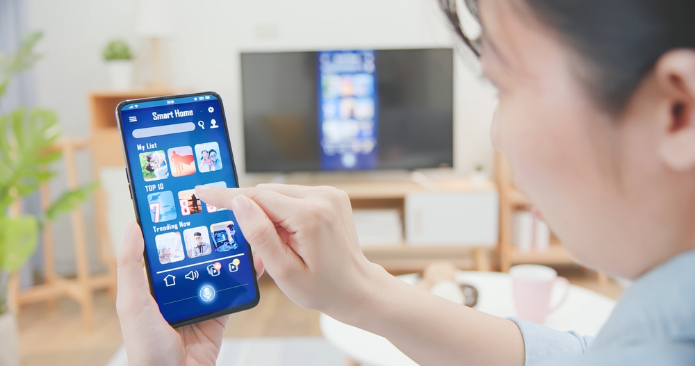 Woman screen mirroring on her Samsung TV