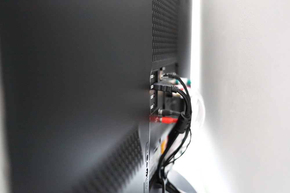 various cables on the back of a TV