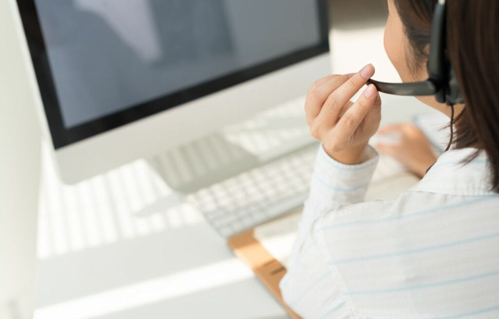 over shoulder view of a customer service support taking calls